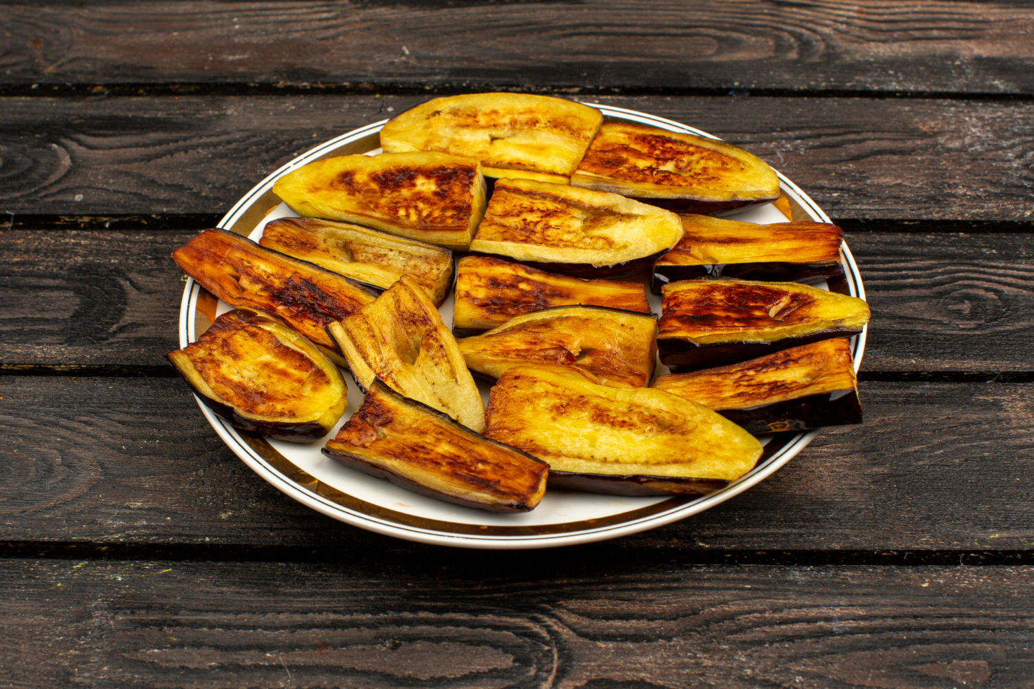 Berenjenas cocinadas en freidora de aire, servidas en un plato blanco.
