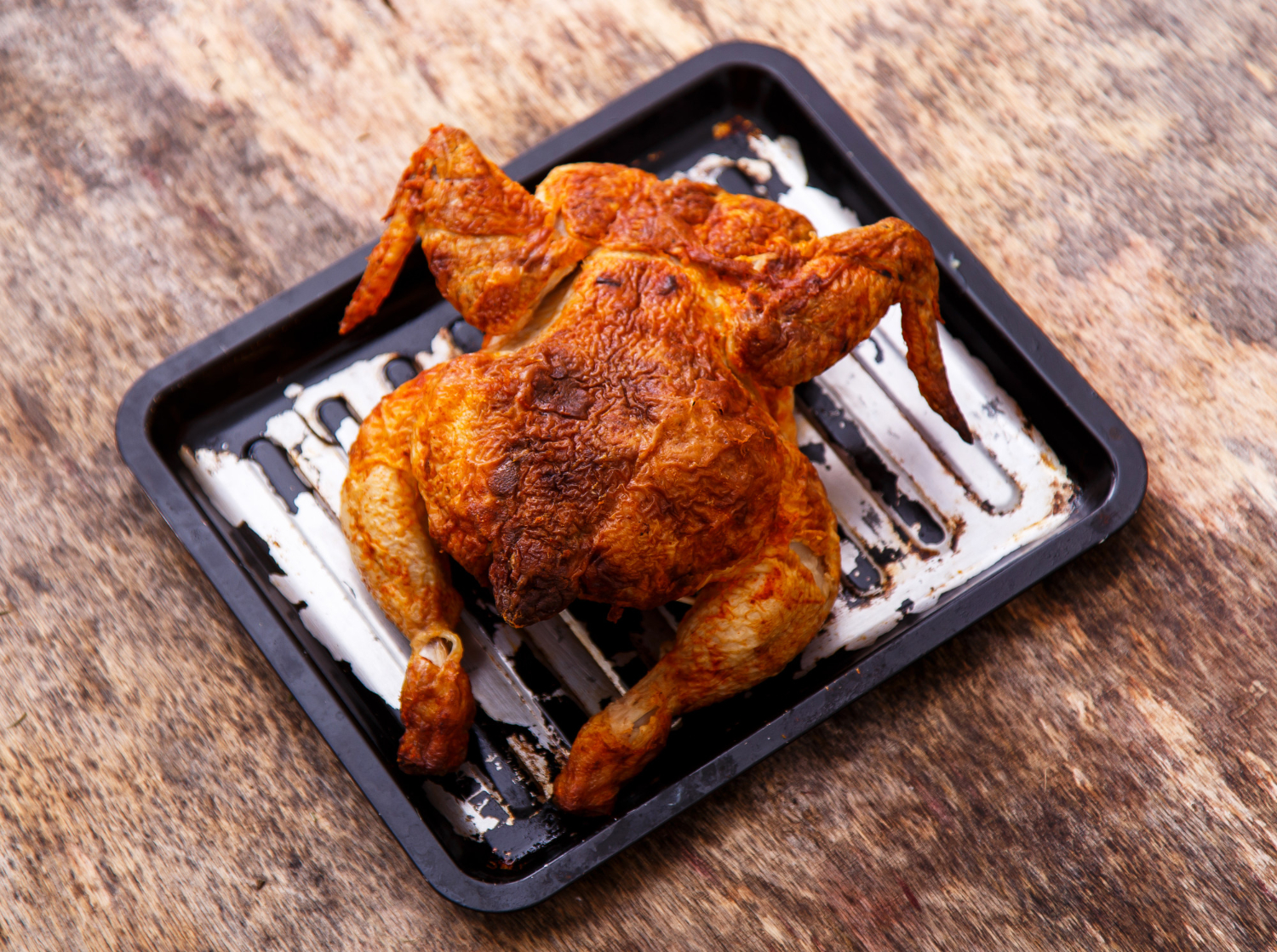 Pollo entero dorado cocinado en una freidora de aire.